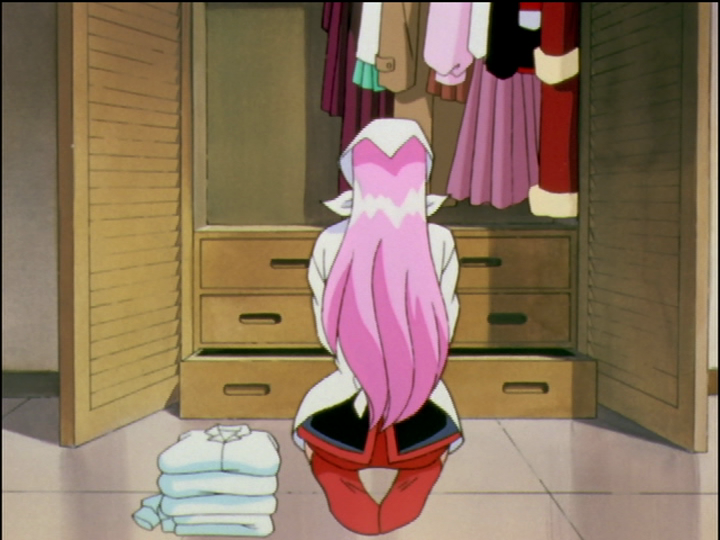 Anthy (in Utena’s body) is sitting, putting away clean clothing in Utena’s wardrobe.