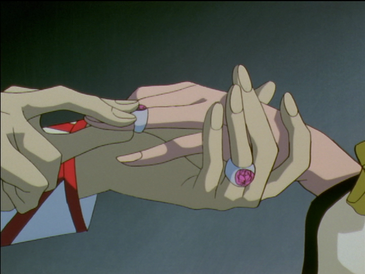 Touga slides Nanami’s new dueling ring onto her finger.