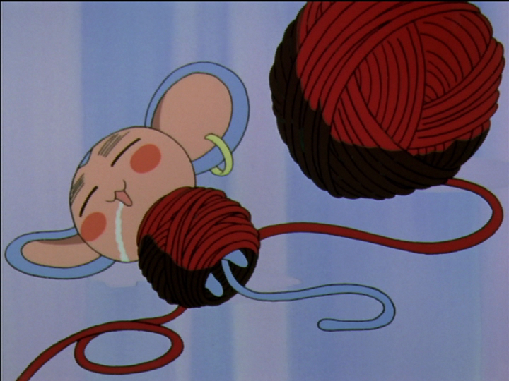 Chu-Chu sleeps wrapped up in the red yarn Anthy is using to knit the sweater that Utena uses as a red cape with Nanami when she turns into a cow.