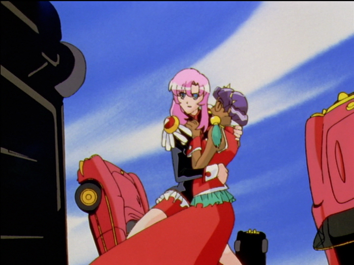Anthy has rushed to Utena, and they collide. Anthy has a hand on Utena’s chest, Utena an arm around Anthy’s waist.