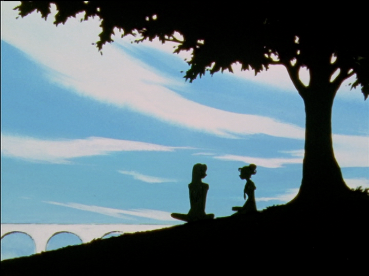 Utena and Wakaba on the grass in silhouette.