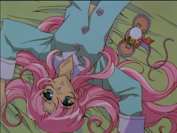 Utena lying in bed in her pajamas.