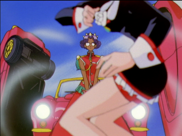 In the dueling arena, Utena dodges empty-handed while Anthy looks on impassively with opaque glasses.