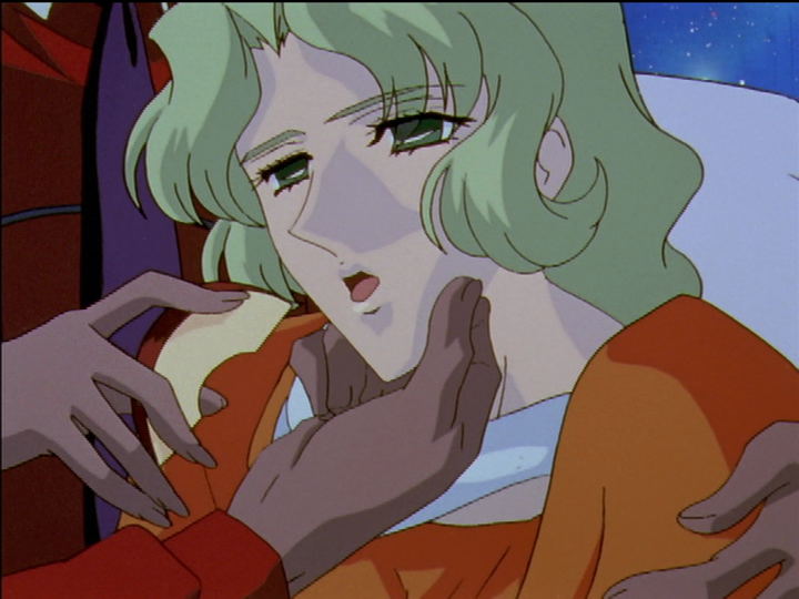 Kanae looks drugged. Akio force-feeds her an apple slice.