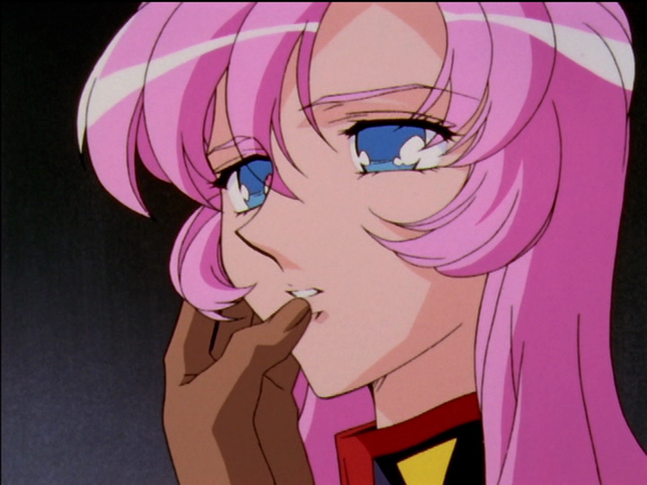 Akio’s left hand is on Utena’s face as he rubs her lips with his thumb.