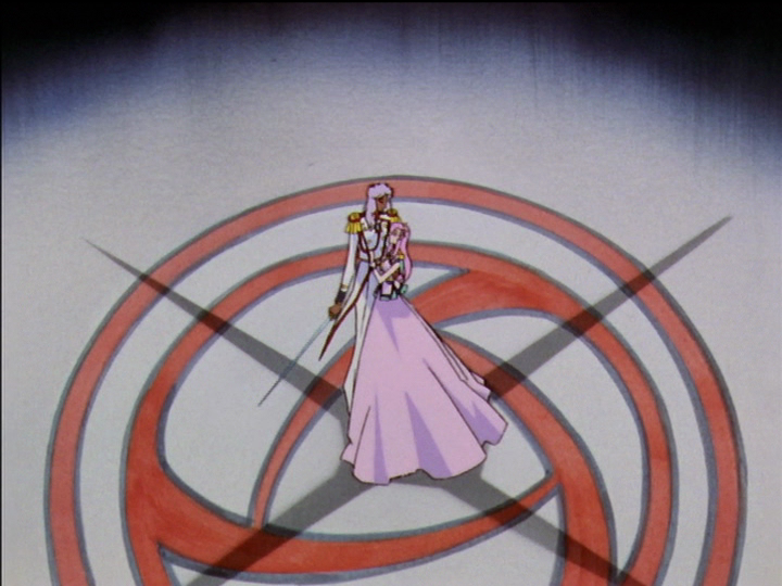 Akio flourishes Utena’s sword. A four-pointed shadow is centered on them.